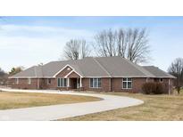 Stunning brick home features a circular driveway and meticulously maintained lawn at 3949 W 250 N, Anderson, IN 46011