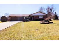 Charming brick home with a well-maintained front lawn and an attached two car garage at 4109 E Epler Ave, Indianapolis, IN 46237