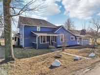 Two-story blue home featuring an sunroom and charming architectural details at 4844 N 700 W, McCordsville, IN 46055