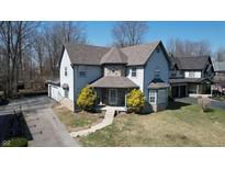 Charming two-story home with stone accents, well-maintained lawn and beautiful front yard landscaping at 5014 Melbourne Rd, Indianapolis, IN 46228
