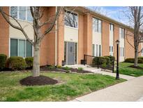 Charming brick exterior with well-maintained landscaping and inviting front entrance at 505 W Hunters Dr # D, Carmel, IN 46032