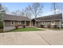 Charming single-story home with a well-manicured lawn and a yellow front door at 5111 S Poplar Dr, Columbus, IN 47201