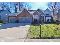 Charming two-story home with a well-maintained lawn and a two-car garage at 5855 Dapple Trce, Indianapolis, IN 46228