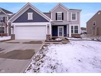 Charming two-story home features a two-car garage and well-maintained landscaping in a suburban neighborhood at 6830 Shooting Star Dr, Whitestown, IN 46075
