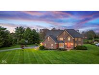 Beautiful brick home with a well-manicured lawn and professional landscaping at 7357 Windridge Way, Brownsburg, IN 46112