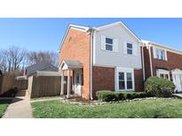 Charming two-story home featuring brick and siding accents, with manicured lawn and inviting front entrance at 7438 Melanie Ln # 13, Indianapolis, IN 46217