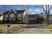 Charming two-story brick home with a well-maintained lawn and mature landscaping at 7474 Oakland Hills Dr, Indianapolis, IN 46236