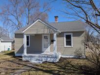 Charming single Gathering home with a cozy front porch and tidy landscaping on a sunny day at 101 N Gladstone Ave, Columbus, IN 47201