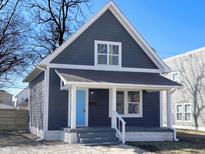 Charming home with a blue door and a cozy front porch at 1011 W 28Th St, Indianapolis, IN 46208