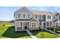 Charming gray two-story townhome with brick accents, manicured lawn, and inviting entrance under a clear blue sky at 2165 Mildred Rd, Westfield, IN 46074