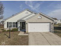 Charming single-story home featuring white siding, brick accents, and an attached two-car garage at 2691 Camelot Way, Greenwood, IN 46143