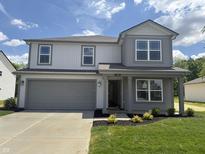Charming two-story home with a well-manicured lawn, a two car garage and appealing architectural details at 3328 Stafford St, Sheridan, IN 46069