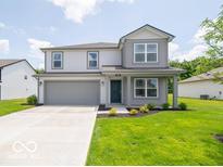 Charming two-story home with gray siding, a well-manicured lawn, and an attached two-car garage at 3328 Stafford St, Sheridan, IN 46069