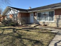 Charming one-story home with brick and stone exterior and well-maintained landscaping at 424 Wayside Dr, Plainfield, IN 46168