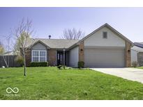 Charming single-story home featuring a well-maintained lawn, brick accents, and an attached two-car garage at 5503 Thompson Park Blvd, Indianapolis, IN 46237