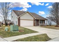 Charming single-Gathering home with a well-manicured lawn and attached two-car garage at 5772 Jamestown Square Ln, Indianapolis, IN 46234