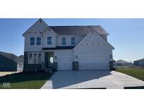 Charming two-story home boasts a three-car garage, stone accents, and a well-manicured lawn at 6323 Willow Branch Way, Plainfield, IN 46168