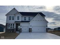 New construction two-story home featuring stone accents, an attached two-car garage and a modern design at 6323 Willow Branch Way, Plainfield, IN 46168