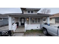 Charming single-story home featuring a welcoming front porch with white pillars and black front door at 644 S Cole St, Indianapolis, IN 46241