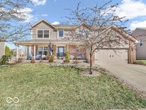 Charming two-story home with a well-manicured lawn and welcoming front porch with brick pillars at 6620 Avalon Blvd, Avon, IN 46123