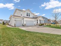Two-story home with gray siding, white trim, a well-manicured lawn, and a three car garage at 6915 Diamondleaf Way, Brownsburg, IN 46112