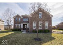 Charming two-story brick home with a well-manicured lawn and a welcoming entrance at 7239 Bellini Ln, Indianapolis, IN 46259