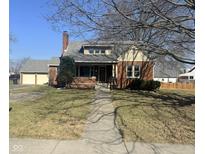 Charming brick home with a well-maintained lawn, inviting entryway, and a detached garage at 730 E Main St, Plainfield, IN 46168