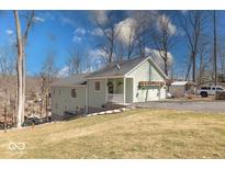 Charming two-story home featuring light green siding and attached two car garage at 8205 Bass Dr, Nineveh, IN 46164