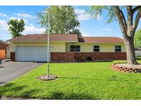Charming ranch-style home featuring a well-manicured lawn and brick accents at 8715 Legion Ln, Indianapolis, IN 46231