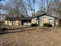 Charming single-story home featuring a classic brick facade and mature trees in a serene neighborhood at 9114 Crestview Dr, Indianapolis, IN 46240