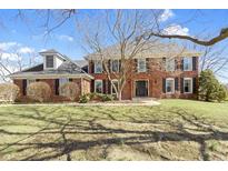 Traditional brick home featuring a symmetrical facade, dormer window and mature landscaping at 10817 Lakeview Dr, Carmel, IN 46033