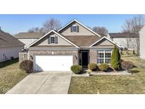 Charming single-Gathering home with a well-manicured front yard and two car garage at 1120 Oak Hill Ln, Cicero, IN 46034