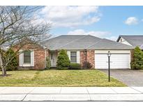 Charming single-story brick home with a well-maintained front yard and attached two-car garage at 12289 Charing Cross Rd, Carmel, IN 46033