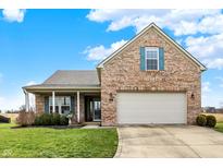 Charming brick home with a well-manicured lawn and two-car garage, perfect for suburban living at 129 W Clear Lake Ln, Westfield, IN 46074