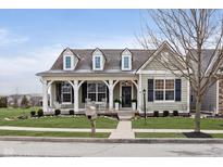 Charming single-Gathering home with a covered porch and swing, complemented by lush landscaping and a welcoming entrance at 15104 Midland Ln, Noblesville, IN 46062