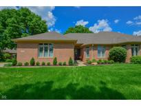 Charming single-story brick home featuring a well-manicured lawn, mature trees and inviting curb appeal at 1738 Pathway S Dr, Greenwood, IN 46143
