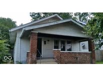 Traditional home featuring a quaint porch and a classic gable roof design at 2022 N Olney St, Indianapolis, IN 46218