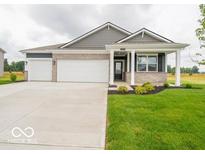 Charming single-story home showcasing a three-car garage, a covered porch, and a well-manicured lawn at 2254 Oakmont Dr, Plainfield, IN 46168