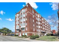 Brick apartment building exterior featuring classic architecture under a partly cloudy sky at 230 E 9Th St # Apt 405, Indianapolis, IN 46204
