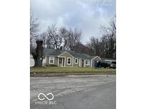 Charming single-story home featuring a well-maintained front yard and a classic facade at 3302 E 42Nd St, Indianapolis, IN 46205