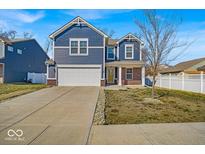 Two-story home with blue siding, white trim, a two-car garage, and a yellow front door at 3602 Shepperton Blvd, Indianapolis, IN 46228