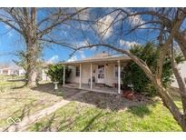 Charming single-story home featuring a covered front porch and mature trees adding curb appeal at 371 Cleveland St, Columbus, IN 47201