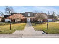 Charming brick home with well-manicured lawn, mature trees, and inviting walkway at 4501 N Wheeling Ave # 6A - 201, Muncie, IN 47304