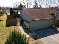 Inviting exterior view featuring a two-car garage and well-manicured landscaping at 4969 Fairway Dr, Avon, IN 46123