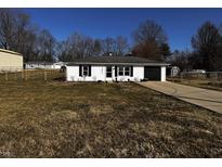 Charming single-story home with a well-manicured front yard and attached garage on a sunny day at 5061 N 200 W, Columbus, IN 47201