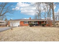 Charming brick ranch home with attached garage and well-maintained lawn, a perfect starter home at 5108 Chatham Pl, Indianapolis, IN 46226