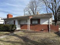 Charming single-story home with a brick foundation, and tidy front yard, ready for your personal touch at 5207 N Sadlier Dr, Indianapolis, IN 46226