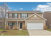 Charming two-story home featuring a brick and siding facade, black shutters, and an attached two-car garage at 6302 Emerald Field Way, Indianapolis, IN 46221