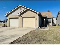Charming single story home with a two car garage, neutral brick, vinyl siding, and well maintained landscaping at 734 W 9Th St, Greenfield, IN 46140