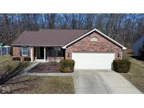 Charming brick home featuring an attached two-car garage and well-maintained landscaping at 7340 Oakview Dr, Avon, IN 46123